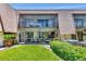 Exterior view of a condo building with screened patios and lush landscaping at 4650 Ringwood Meadow # 37, Sarasota, FL 34235