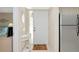 Bright condo foyer with tile flooring, white decor, a welcome mat, and an adjacent stainless steel refrigerator at 4650 Ringwood Meadow # 37, Sarasota, FL 34235