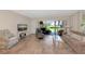 Bright living room with tile floors, neutral decor, and sliding glass doors to a screened patio at 4650 Ringwood Meadow # 37, Sarasota, FL 34235