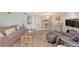 Open-concept living room connects to dining area with neutral decor and access to kitchen at 4650 Ringwood Meadow # 37, Sarasota, FL 34235