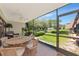 View of the screened-in patio with a dining table set and outdoor seating at 4650 Ringwood Meadow # 37, Sarasota, FL 34235