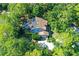 A home with a tile roof and solar panels, surrounded by lush greenery and a refreshing pool at 4917 Leatha Ln, Sarasota, FL 34232