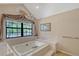 Bright bathroom features a soaking tub, a large window, and stylish accents at 4917 Leatha Ln, Sarasota, FL 34232