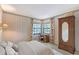 Comfortable bedroom with a desk, wardrobe, and ample natural light from the windows at 4917 Leatha Ln, Sarasota, FL 34232