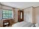 Charming bedroom with a quaint writing desk, large window, and built-in closet at 4917 Leatha Ln, Sarasota, FL 34232