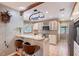 Open-concept kitchen with counter seating, stainless steel appliances, and decorative touches at 4917 Leatha Ln, Sarasota, FL 34232
