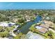 Aerial view showcasing waterfront homes with docks and boat access, set amongst lush landscaping at 5223 Shadow Lawn Dr, Sarasota, FL 34242