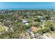 Scenic aerial view of a residential area featuring lush landscaping and waterfront views at 5223 Shadow Lawn Dr, Sarasota, FL 34242