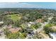 Aerial view of the property nestled among lush greenery and landscaping in a quiet neighborhood at 5223 Shadow Lawn Dr, Sarasota, FL 34242