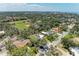 Aerial view of the property nestled among lush greenery and landscaping in a quiet neighborhood at 5223 Shadow Lawn Dr, Sarasota, FL 34242
