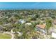 Expansive aerial view of a lush neighborhood with mature trees, waterways, and homes near the beautiful ocean at 5223 Shadow Lawn Dr, Sarasota, FL 34242