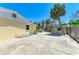 A side view of a large concrete patio, palm tree, and storage shed is seen at 5223 Shadow Lawn Dr, Sarasota, FL 34242