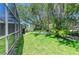 A lush backyard features mature trees and a tranquil setting for outdoor enjoyment at 5223 Shadow Lawn Dr, Sarasota, FL 34242