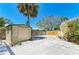 A storage shed and gravel patio create a functional and stylish outdoor space at 5223 Shadow Lawn Dr, Sarasota, FL 34242