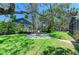 Private backyard area with a stone firepit, perfect for outdoor relaxation and entertaining at 5223 Shadow Lawn Dr, Sarasota, FL 34242