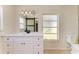 Updated bathroom with a white vanity, sliding barn door mirror and natural light at 5223 Shadow Lawn Dr, Sarasota, FL 34242