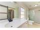 Updated bathroom features a white vanity, barn door mirror, and a glass enclosed shower at 5223 Shadow Lawn Dr, Sarasota, FL 34242