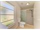 Bathroom featuring a glass enclosed shower and a frosted window for natural light at 5223 Shadow Lawn Dr, Sarasota, FL 34242