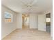 Bright bedroom with wood-look floors and views of the updated bathroom and hallway at 5223 Shadow Lawn Dr, Sarasota, FL 34242