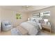 The staged bedroom is airy and bright with a relaxed, beachy aesthetic at 5223 Shadow Lawn Dr, Sarasota, FL 34242