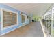 A spacious covered patio provides shade and an extension of living space from the home at 5223 Shadow Lawn Dr, Sarasota, FL 34242