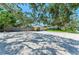 A large driveway and well-maintained yard add to the curb appeal of this home at 5223 Shadow Lawn Dr, Sarasota, FL 34242
