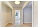 Bright hallway featuring wood floors and an entrance to a bathroom with updated vanity at 5223 Shadow Lawn Dr, Sarasota, FL 34242