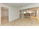 Spacious living area with wood-look flooring and an open layout connecting to the kitchen at 5223 Shadow Lawn Dr, Sarasota, FL 34242