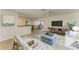 A staged living room boasts new flooring and neutral, relaxing decor at 5223 Shadow Lawn Dr, Sarasota, FL 34242