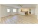 Bright living room featuring wood-look flooring, ceiling fan, and breakfast bar area at 5223 Shadow Lawn Dr, Sarasota, FL 34242