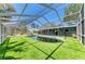Inviting screened-in pool area featuring artificial turf for low maintenance at 5223 Shadow Lawn Dr, Sarasota, FL 34242