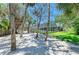 A screened pool area is surrounded by beautiful, mature landscaping and shady trees at 5223 Shadow Lawn Dr, Sarasota, FL 34242