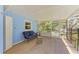 A charming screened porch furnished with a loveseat provides outdoor living at 5223 Shadow Lawn Dr, Sarasota, FL 34242