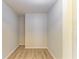 Bright walk-in closet features wood-look floors and white walls at 5223 Shadow Lawn Dr, Sarasota, FL 34242