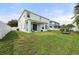 Backyard features a covered patio, green grass and full lake view at 5224 58Th E Ter, Bradenton, FL 34203