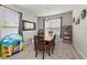 Well-lit dining area with a wooden table, a window, and a decorative mirror at 5224 58Th E Ter, Bradenton, FL 34203