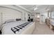 Bright primary bedroom with tray ceilings, neutral decor, and attached room at 5224 58Th E Ter, Bradenton, FL 34203