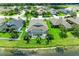 An aerial view of the home’s screened pool and backyard, backing onto a peaceful lake with swaying palm trees at 5319 120Th E Ave, Parrish, FL 34219