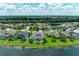Aerial view showcasing the homes' backyard pools and lush landscaping, backing onto a tranquil lake setting at 5319 120Th E Ave, Parrish, FL 34219