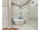 Main bathroom showcases a standalone tub and a large frameless glass shower with rain shower head and handheld sprayer at 5319 120Th E Ave, Parrish, FL 34219