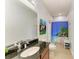 Bathroom with granite countertop vanity, beach themed shower curtain, and beach scene art on the wall at 5319 120Th E Ave, Parrish, FL 34219