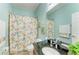 Colorful bathroom features a sink with granite countertop, a bright shower curtain, and a convenient toilet area at 5319 120Th E Ave, Parrish, FL 34219
