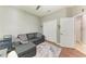 Relaxing bedroom with a comfortable gray sofa, closet, and soft rug, creating a serene space at 5319 120Th E Ave, Parrish, FL 34219
