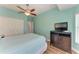 Bedroom featuring serene blue walls, ceiling fan, and modern dresser with flatscreen TV at 5319 120Th E Ave, Parrish, FL 34219