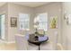 Bright dining area features a round table and chairs, lots of natural light, and access to the backyard at 5319 120Th E Ave, Parrish, FL 34219