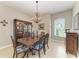 Charming dining room with chandelier and a beautiful wood table with seating for six at 5319 120Th E Ave, Parrish, FL 34219