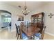 Elegant dining room with a dark wood table, chandelier, and a beautiful china cabinet at 5319 120Th E Ave, Parrish, FL 34219