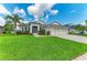 Charming single-story home with well-kept lawn, front garden, and a two-car garage at 5319 120Th E Ave, Parrish, FL 34219