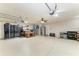 Spacious garage with epoxy flooring, storage cabinets, work benches and extra refrigerator at 5319 120Th E Ave, Parrish, FL 34219