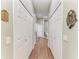 Hallway leading to the main bathroom featuring wood floors and multiple linen closets at 5319 120Th E Ave, Parrish, FL 34219
